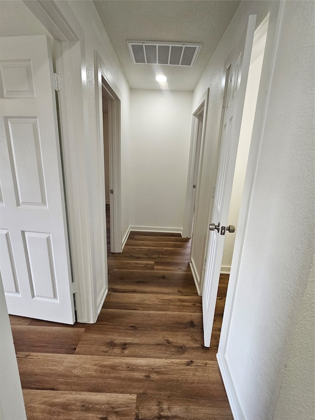 hallway with dark hardwood / wood-style floors