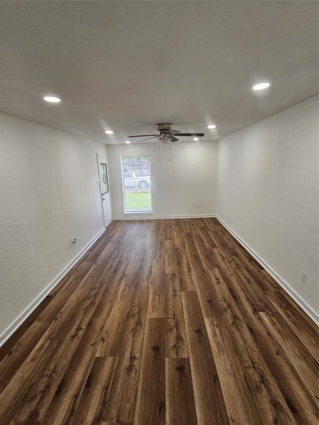 empty room featuring ceiling fan and dark hardwood / wood-style flooring