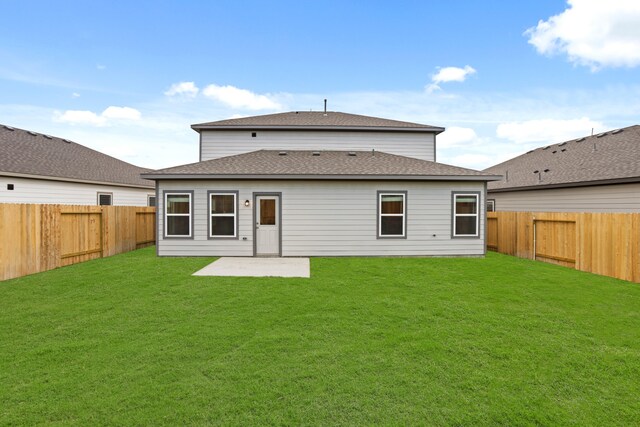 back of property featuring a patio area and a yard