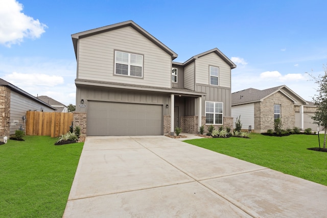 view of front of house featuring a front yard and a garage