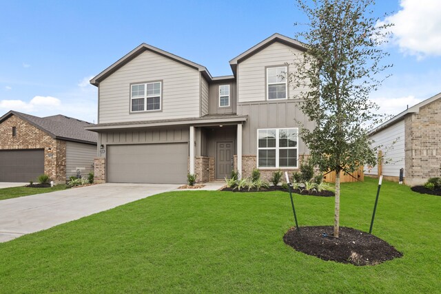 craftsman house featuring a front yard and a garage