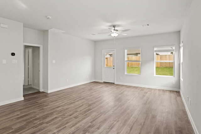 unfurnished room featuring ceiling fan and dark hardwood / wood-style flooring