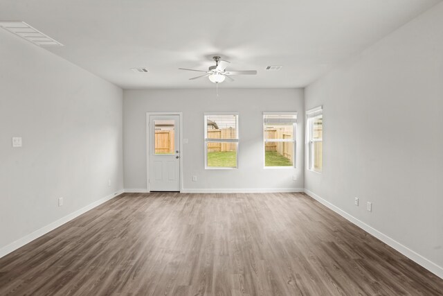 spare room featuring ceiling fan and dark wood-type flooring