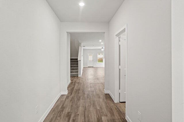 hallway with hardwood / wood-style floors