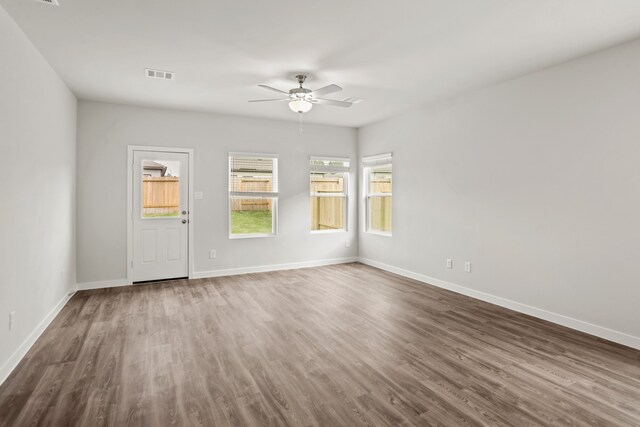 unfurnished room with ceiling fan and dark hardwood / wood-style flooring