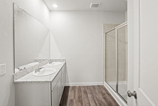 bathroom featuring vanity, hardwood / wood-style floors, and an enclosed shower