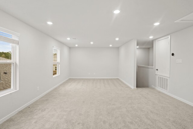 spare room featuring light colored carpet