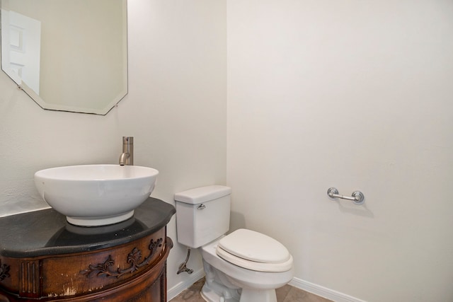 bathroom featuring tile patterned flooring, vanity, and toilet