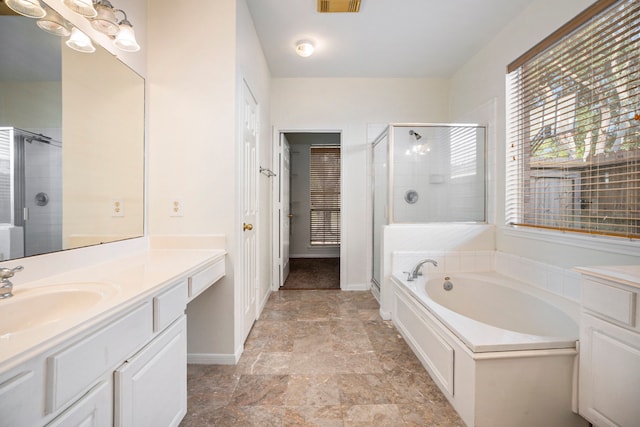 bathroom with vanity and separate shower and tub