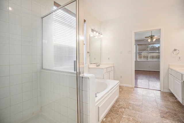 bathroom featuring plus walk in shower, vanity, and ceiling fan