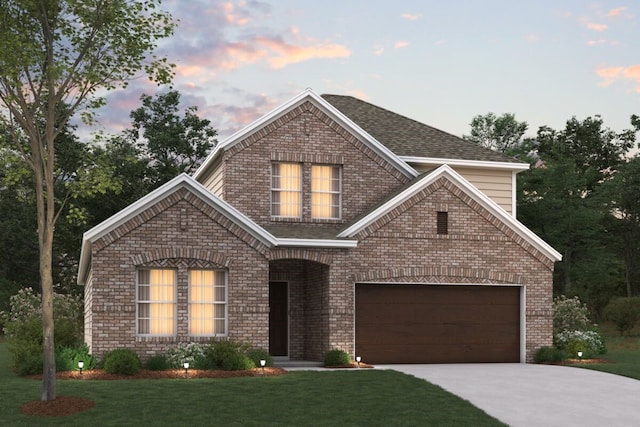 view of front facade with a garage and a lawn