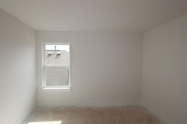 spare room with baseboards and a wealth of natural light