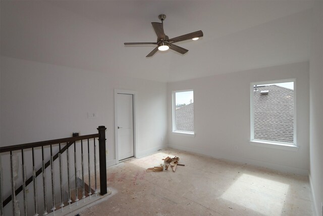 spare room featuring ceiling fan and baseboards