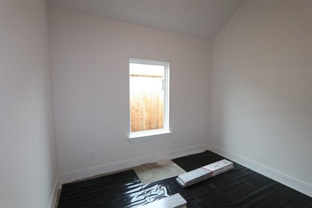 empty room with baseboards and wood finished floors