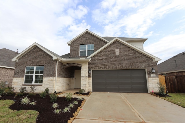 view of front of property featuring brick siding, driveway, a garage, and fence