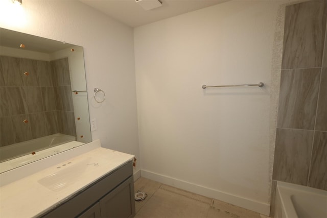 full bathroom with vanity, tile patterned floors, washtub / shower combination, and baseboards