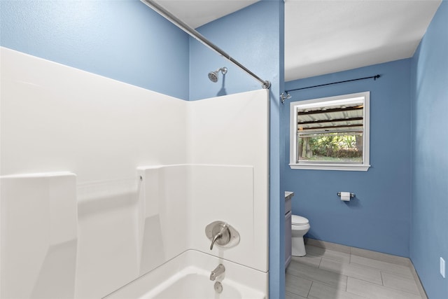 bathroom with toilet and bathtub / shower combination