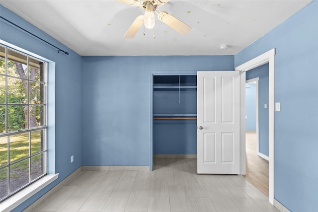 unfurnished bedroom with a closet and ceiling fan