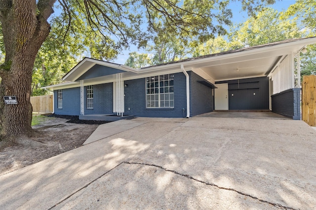 ranch-style home with a carport and a porch