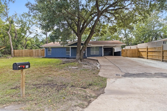 single story home featuring a carport and a front yard