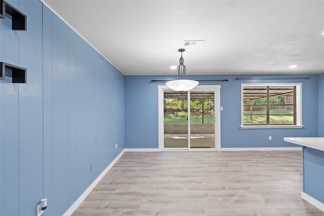 unfurnished dining area with light hardwood / wood-style flooring