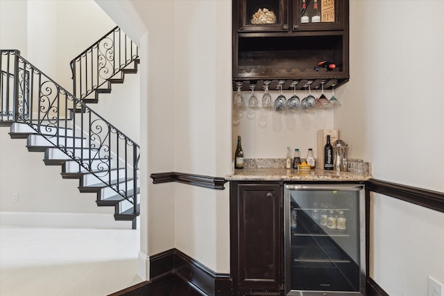 bar featuring dark brown cabinets and beverage cooler