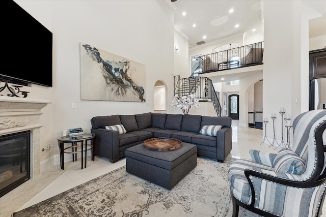 living room featuring ornamental molding and a towering ceiling