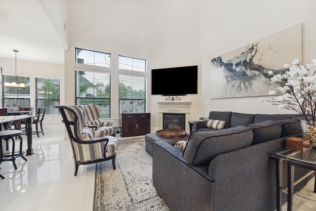 living room featuring a towering ceiling and light tile patterned floors