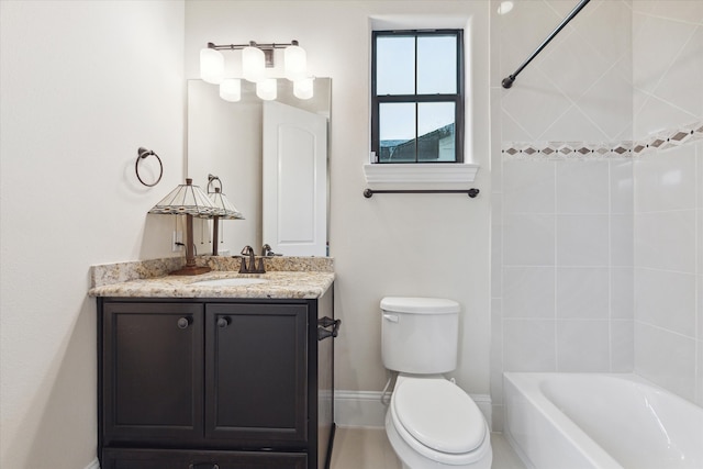 full bathroom featuring vanity, toilet, and tiled shower / bath