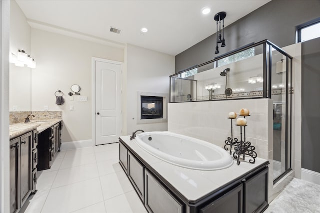 bathroom featuring shower with separate bathtub, tile patterned flooring, and vanity