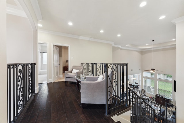 hallway with dark hardwood / wood-style floors and crown molding