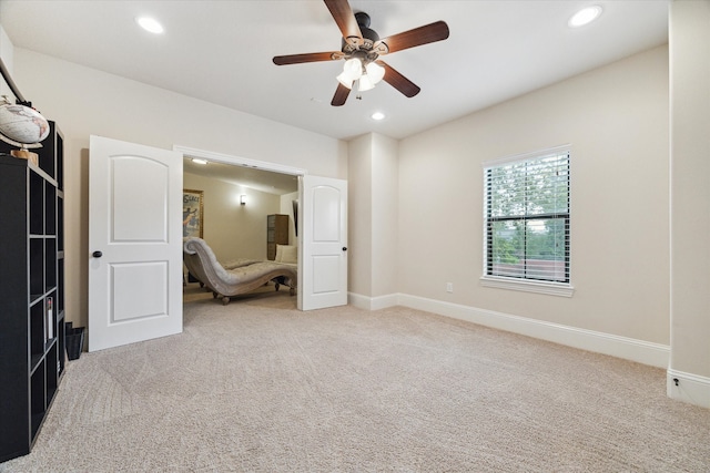 unfurnished bedroom with ceiling fan and light carpet