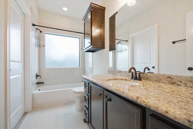 full bathroom with tile patterned flooring, tiled shower / bath, vanity, and toilet