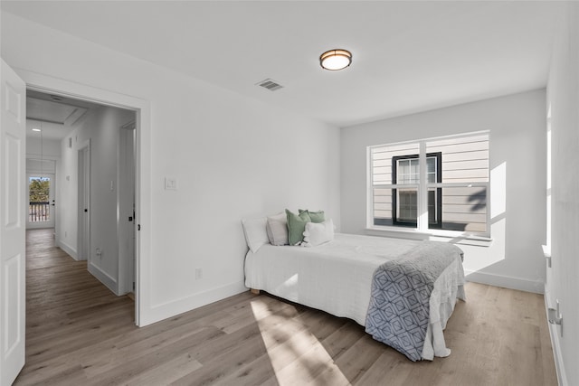 bedroom featuring multiple windows and light wood-type flooring