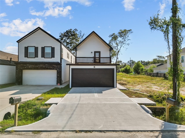 view of front of property featuring a garage and a balcony