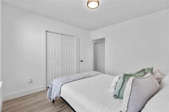 bedroom featuring light hardwood / wood-style flooring and a closet