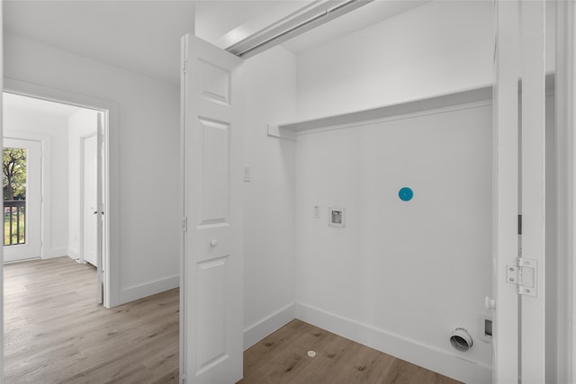 laundry room featuring washer hookup and light wood-type flooring