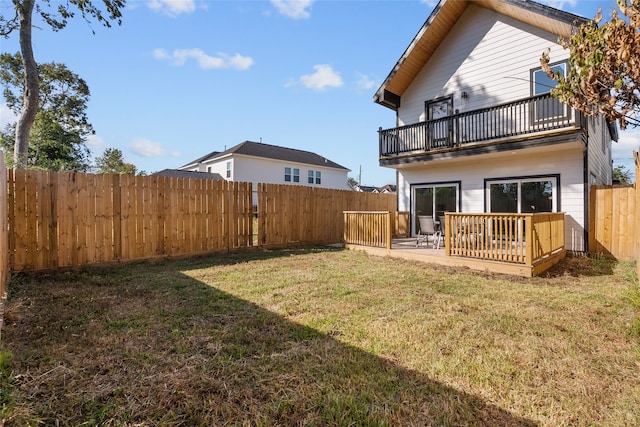 back of property with a patio area, a yard, and a balcony