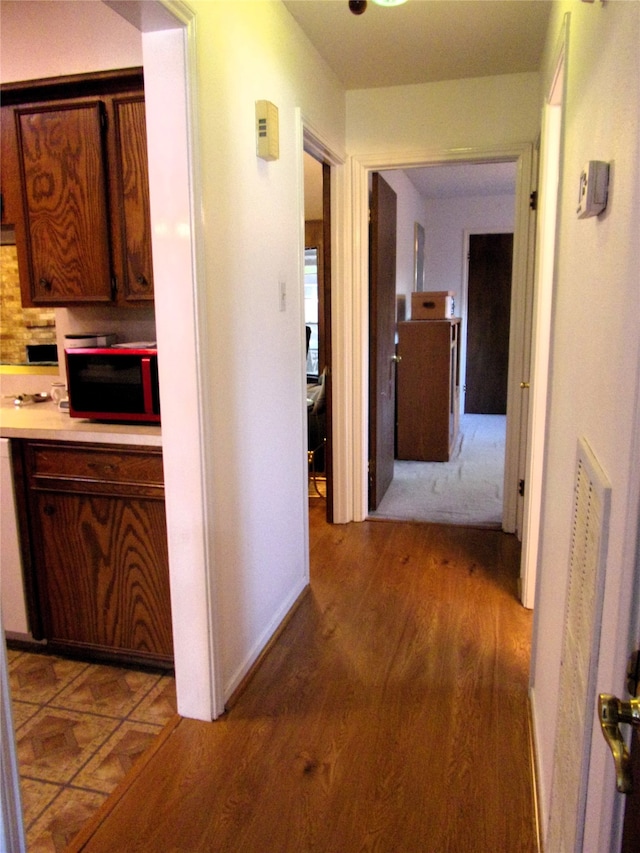 hall with light hardwood / wood-style floors