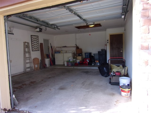 garage with a garage door opener and washing machine and clothes dryer