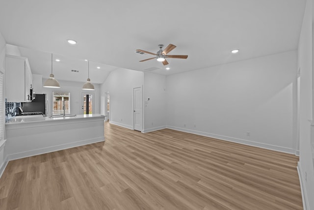 unfurnished living room featuring light wood finished floors, baseboards, recessed lighting, visible vents, and ceiling fan
