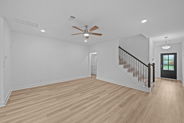 unfurnished living room featuring stairs, light wood-style floors, visible vents, and recessed lighting