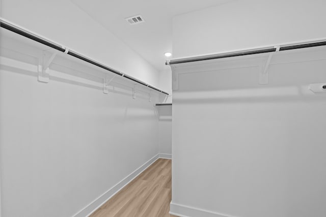 walk in closet with light wood-style floors and visible vents