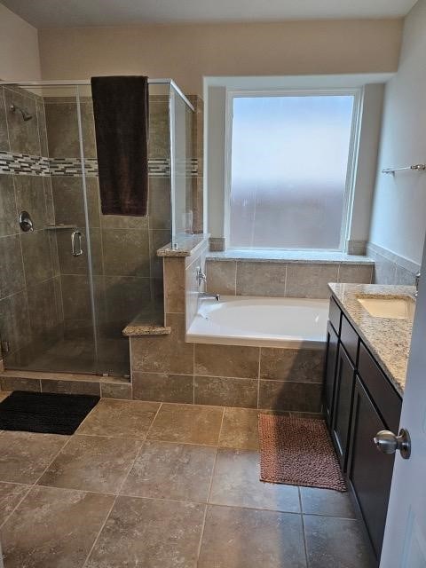 bathroom with plus walk in shower and vanity