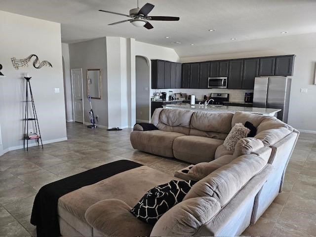 living room with ceiling fan and sink