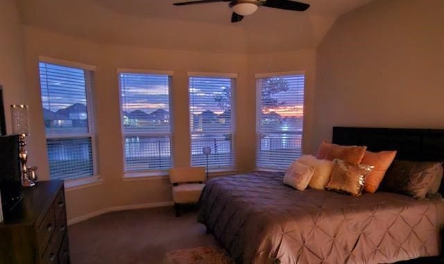 carpeted bedroom featuring ceiling fan and vaulted ceiling