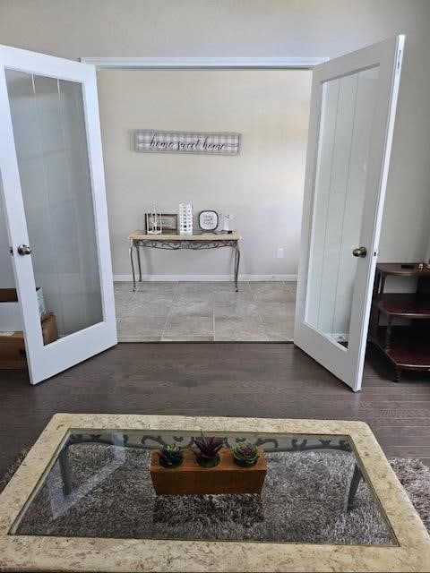 interior space with french doors and hardwood / wood-style flooring