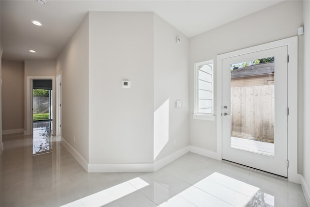 entrance foyer with light tile patterned floors and a healthy amount of sunlight