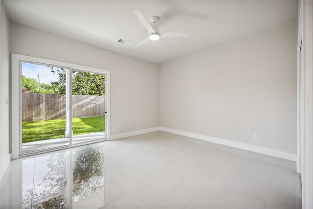 tiled empty room featuring ceiling fan