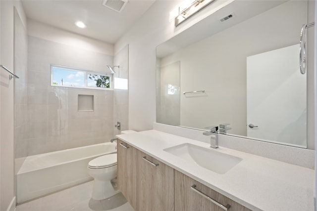 full bathroom featuring tile patterned flooring, vanity, toilet, and tiled shower / bath